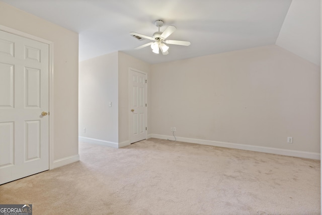 additional living space with lofted ceiling, light carpet, and ceiling fan