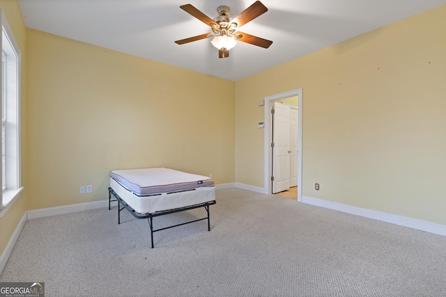 recreation room with light colored carpet and ceiling fan