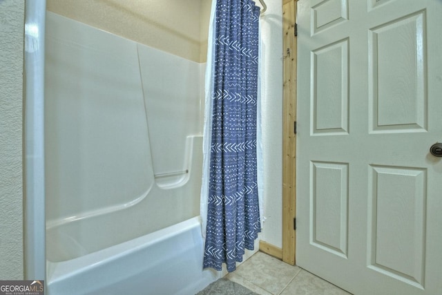 bathroom with shower / bathtub combination with curtain and tile patterned floors