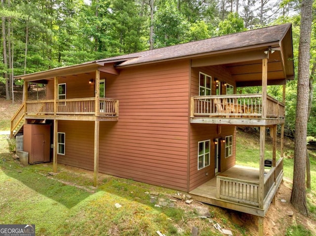 view of property exterior featuring a wooden deck and a yard