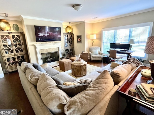 living room with ornamental molding, a fireplace, and wood-type flooring