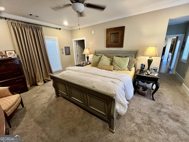 carpeted bedroom featuring ceiling fan and ornamental molding