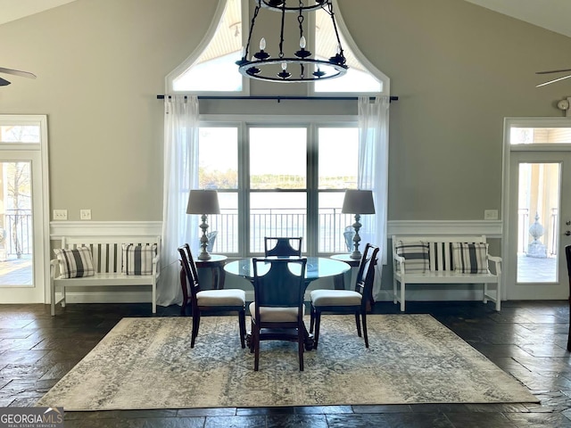 dining area with an inviting chandelier and high vaulted ceiling