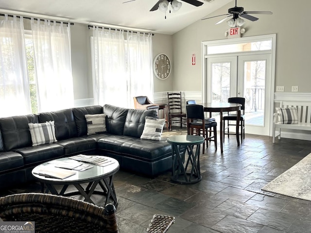 living room featuring lofted ceiling, french doors, and ceiling fan