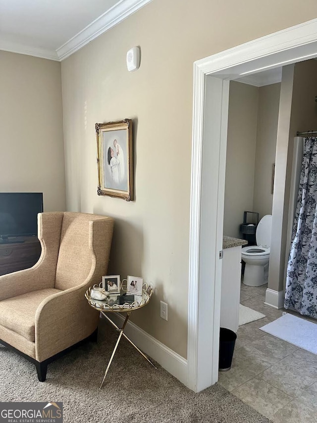 living area with crown molding