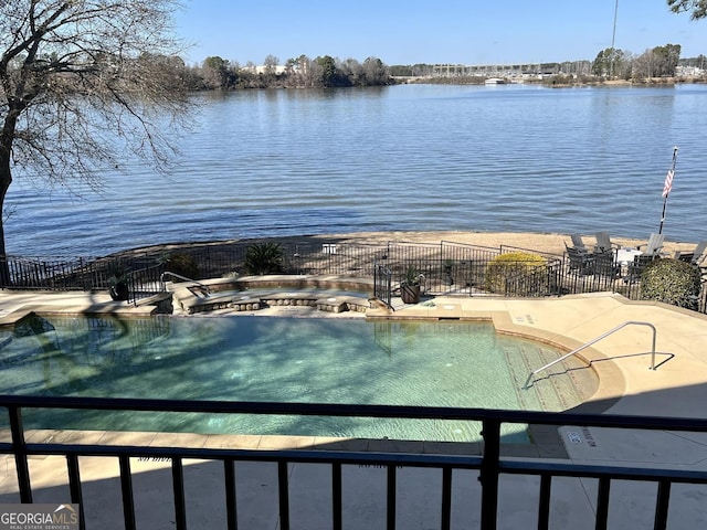 view of swimming pool featuring a water view and a patio area