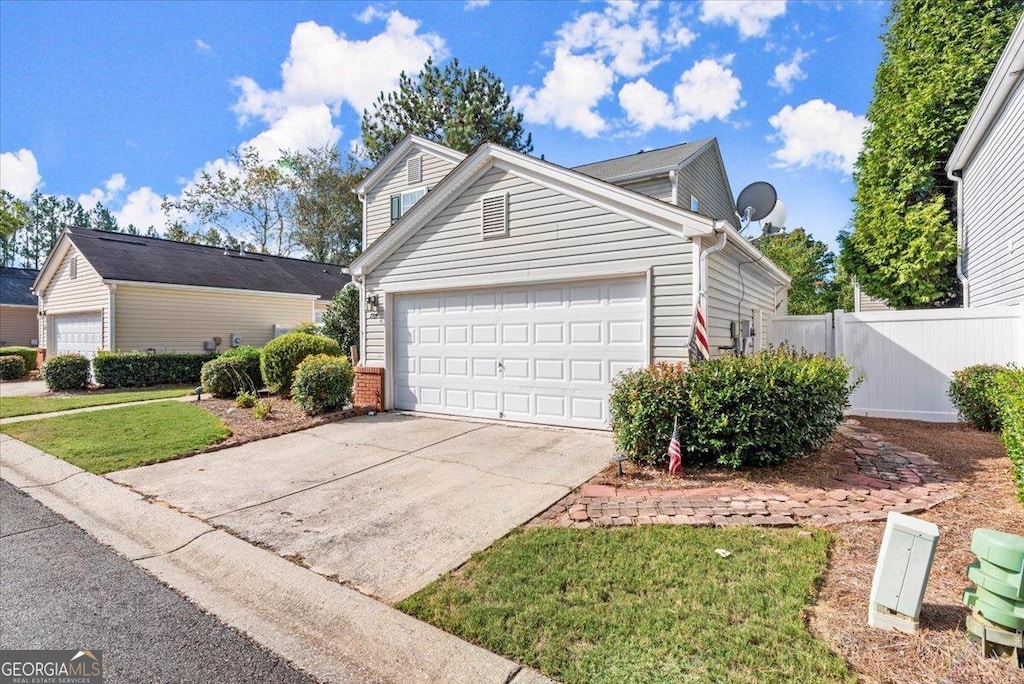 exterior space featuring a garage and a front yard