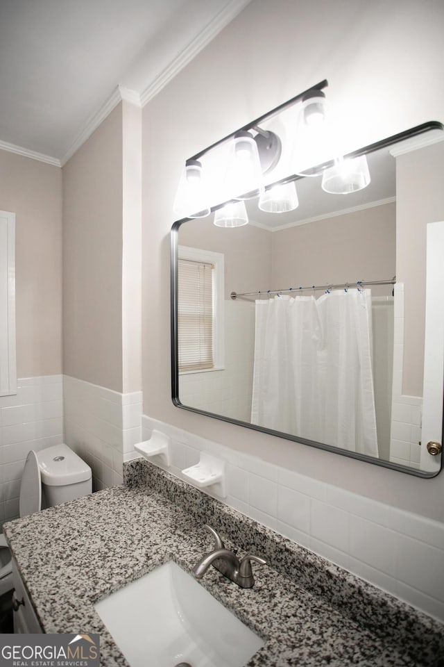 bathroom featuring tile walls, ornamental molding, vanity, toilet, and a shower with shower curtain