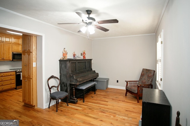 sitting room with crown molding, ceiling fan, and light hardwood / wood-style flooring