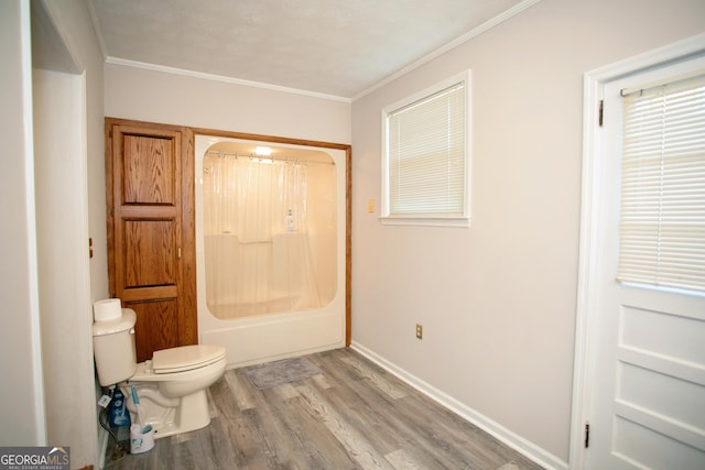 bathroom with shower / bathtub combination with curtain, hardwood / wood-style floors, ornamental molding, and toilet