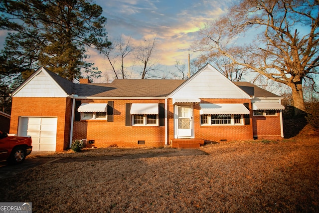 ranch-style home featuring a garage