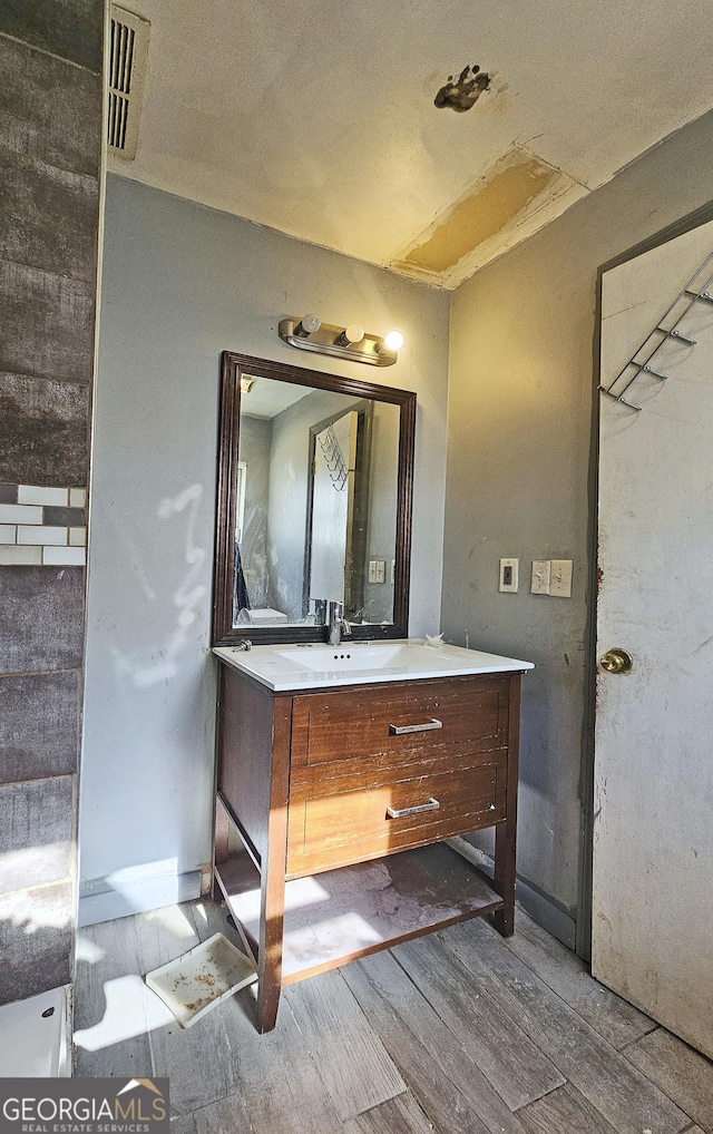 bathroom featuring vanity and hardwood / wood-style floors