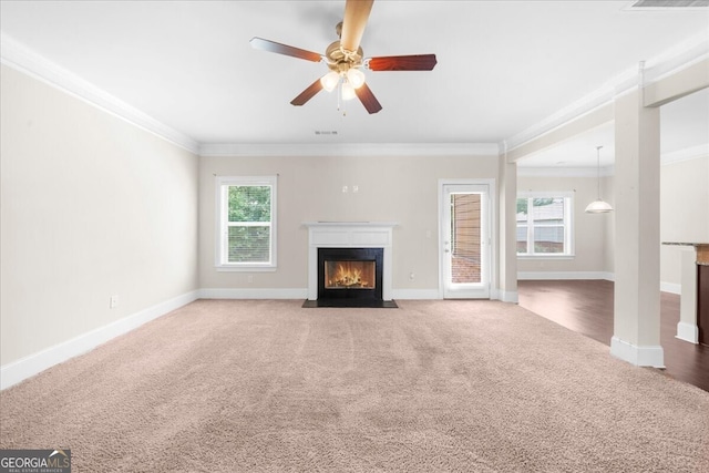 unfurnished living room with crown molding, plenty of natural light, and carpet flooring