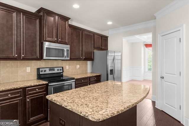 kitchen featuring dark brown cabinetry, appliances with stainless steel finishes, and a kitchen island