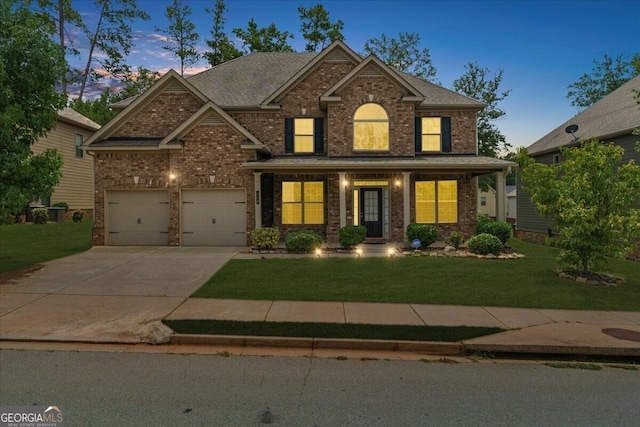 craftsman inspired home featuring a yard and a garage