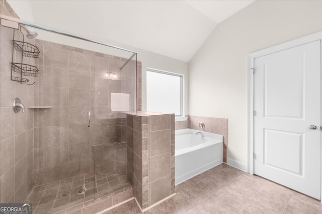 bathroom featuring tile patterned flooring, vaulted ceiling, and separate shower and tub