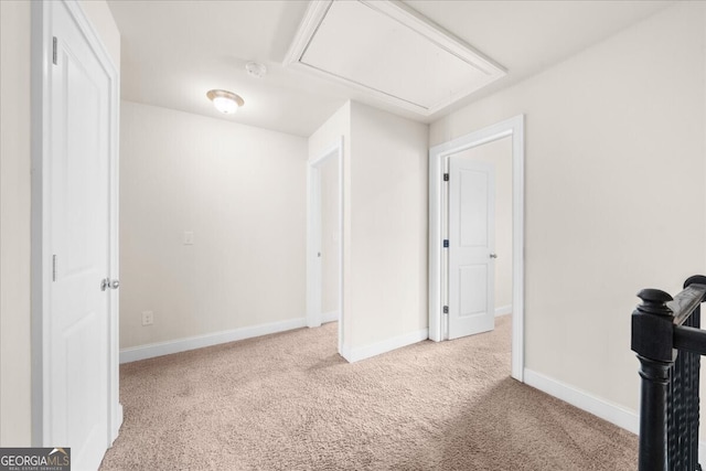 unfurnished room featuring light carpet