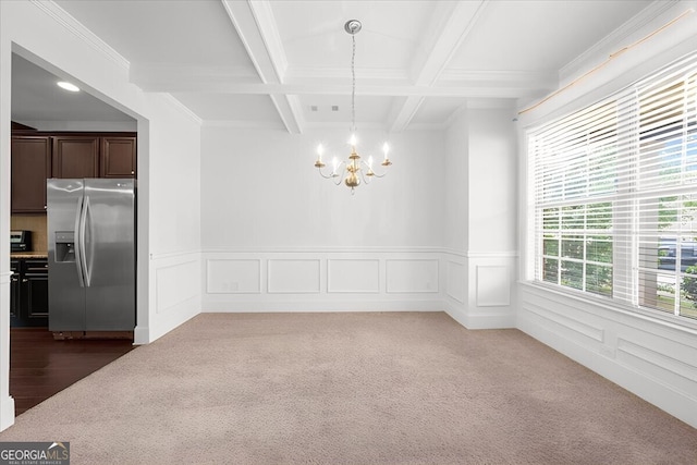 unfurnished dining area with a chandelier, dark colored carpet, ornamental molding, coffered ceiling, and beam ceiling