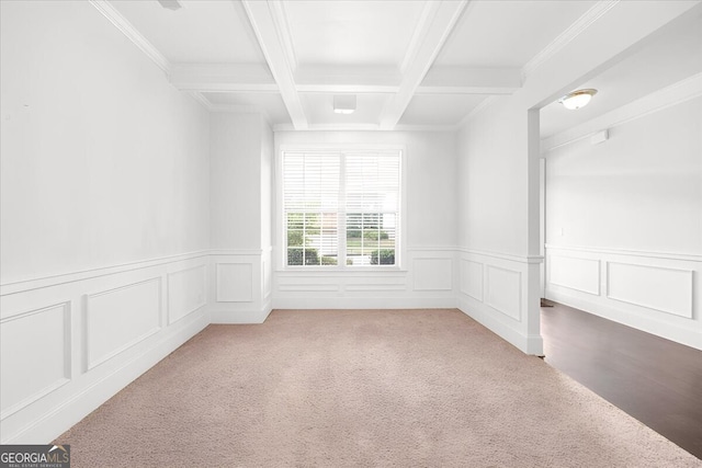 unfurnished room featuring beamed ceiling, coffered ceiling, carpet flooring, and crown molding