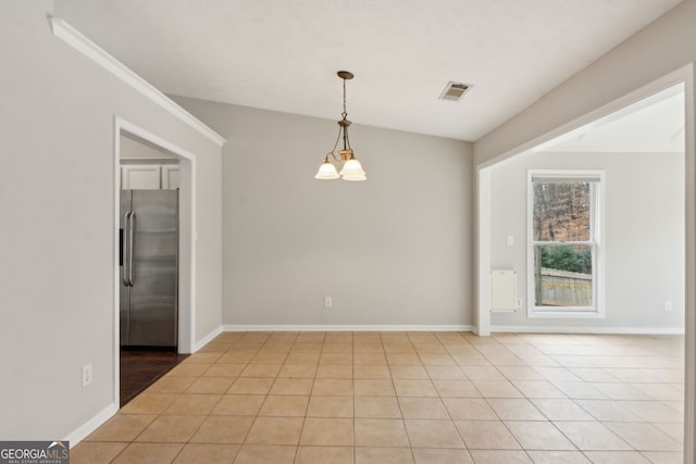 unfurnished room featuring an inviting chandelier and light tile patterned floors