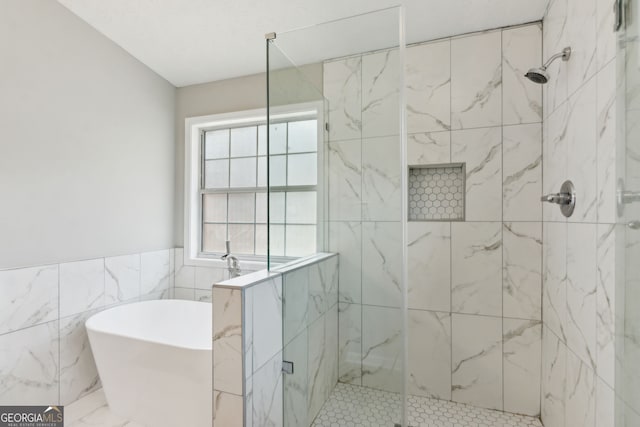 bathroom with separate shower and tub and tile walls