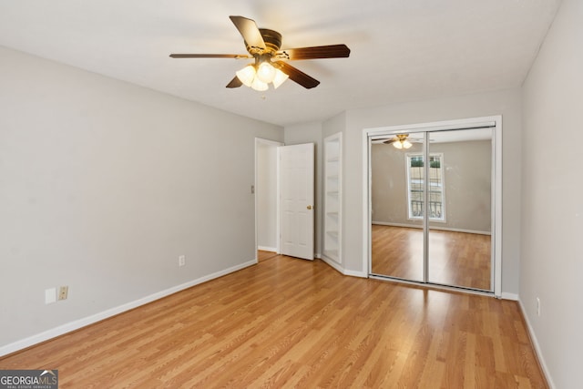 unfurnished bedroom featuring a closet, ceiling fan, and light wood-type flooring