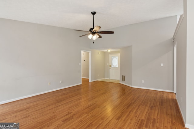 empty room featuring ceiling fan and hardwood / wood-style floors