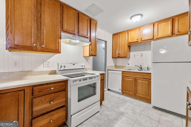 kitchen featuring white appliances and sink