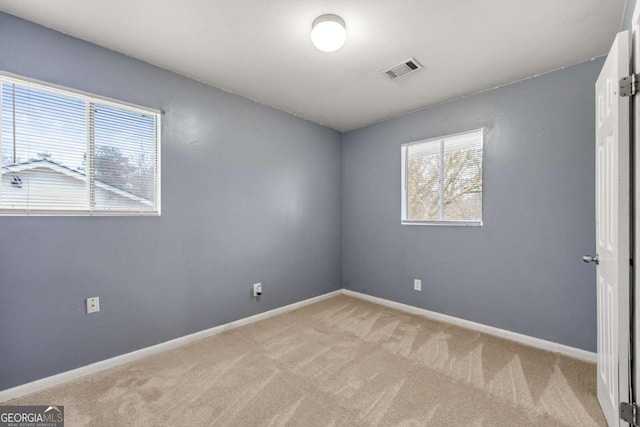 empty room featuring light carpet