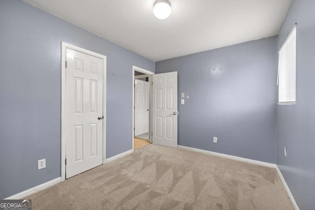 unfurnished bedroom featuring light colored carpet