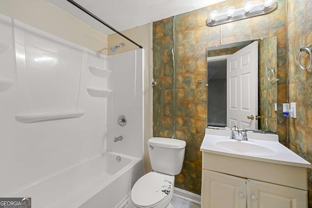 full bathroom with tile walls, vanity, toilet, and washtub / shower combination