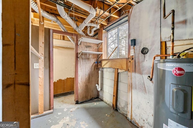 interior space featuring electric water heater and concrete floors