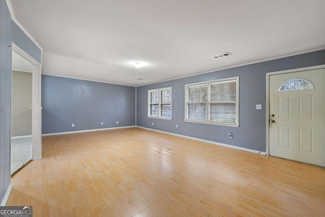 entrance foyer with crown molding and light wood-type flooring