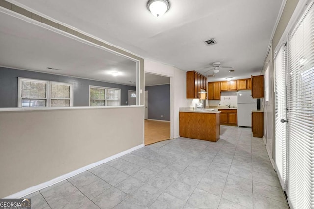 kitchen with ceiling fan and white refrigerator