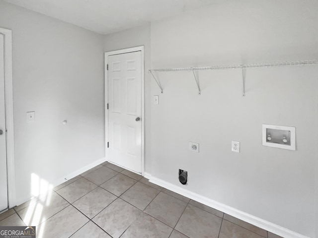 laundry area with electric dryer hookup, hookup for a washing machine, and tile patterned floors