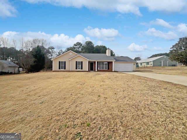 single story home with a garage and a front lawn