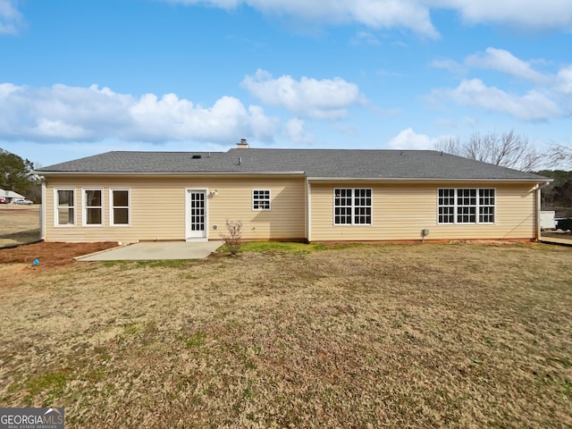 rear view of property with a yard and a patio