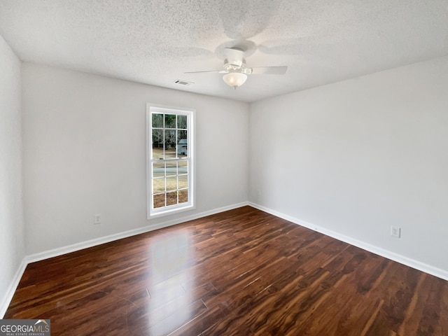 unfurnished room with dark wood-type flooring, a textured ceiling, and ceiling fan