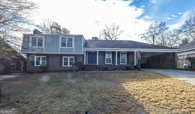 split level home with a front lawn and a carport