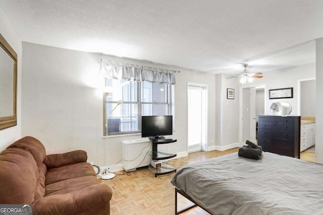 bedroom featuring ceiling fan, a textured ceiling, and light parquet floors