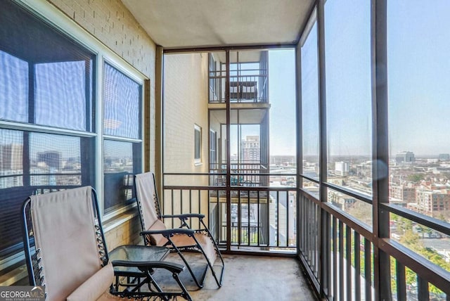 sunroom featuring a city view