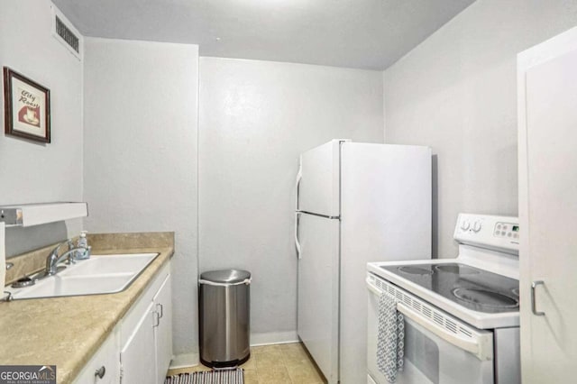 kitchen with white cabinetry, sink, white appliances, and light tile patterned flooring