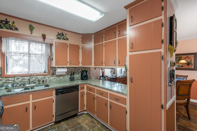 kitchen with light stone countertops, appliances with stainless steel finishes, sink, and backsplash