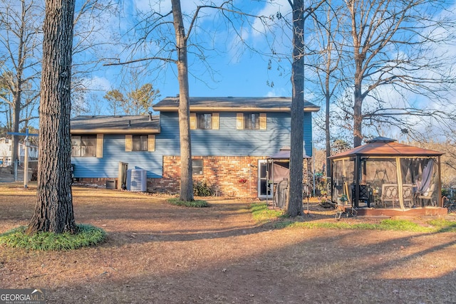 rear view of house featuring a gazebo and central AC