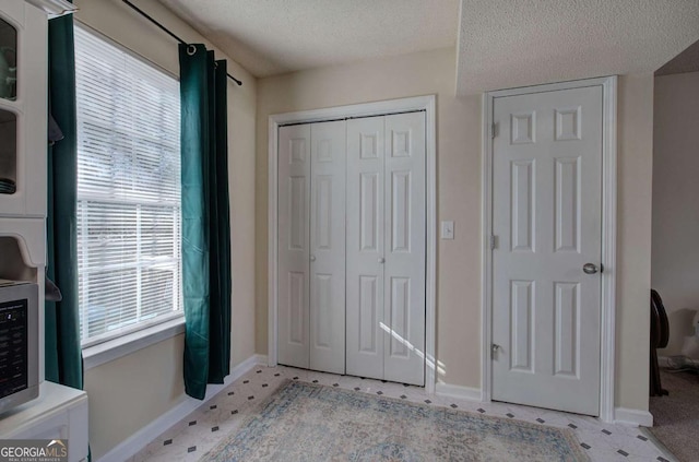 unfurnished bedroom with a closet and a textured ceiling