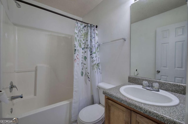 full bathroom featuring vanity, shower / bath combo, toilet, and a textured ceiling