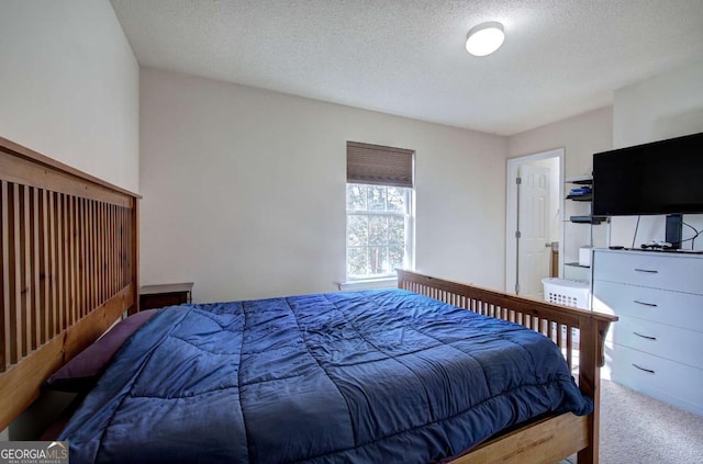 bedroom with carpet flooring and a textured ceiling