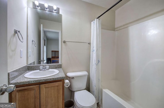 full bathroom with vanity, shower / bath combo, and toilet