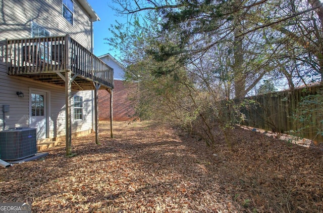 view of yard featuring cooling unit and a deck