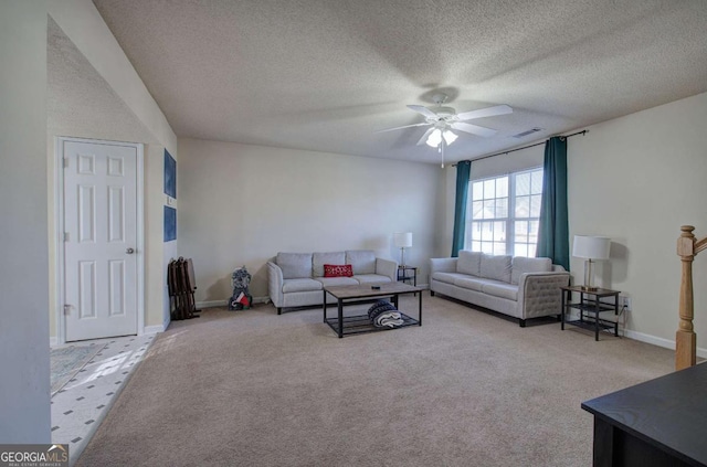 carpeted living room with a textured ceiling and ceiling fan